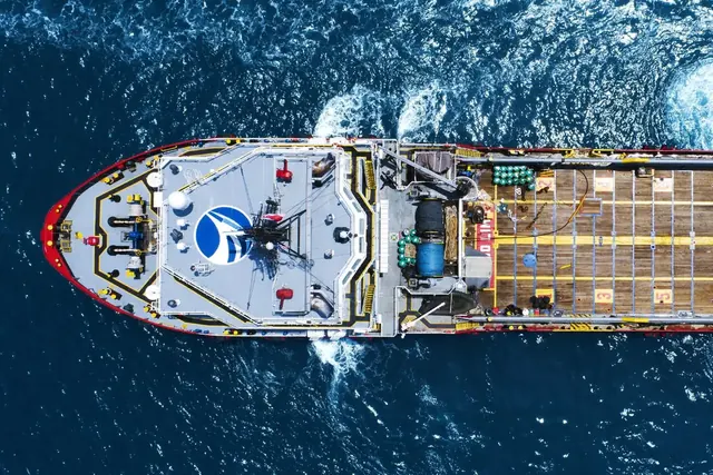 Top-down view of an offshore vessel with a helideck and cargo deck